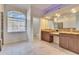 Bright bathroom featuring dual vanities, granite countertops, and abundant natural light from a large arched window at 958 Lake Deeson Pt, Lakeland, FL 33805