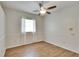 Bedroom with a wood-look floor, ceiling fan, and bright natural light at 958 Lake Deeson Pt, Lakeland, FL 33805