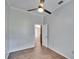 Bright bedroom featuring hardwood floors, a ceiling fan, and an open doorway leading to another room at 958 Lake Deeson Pt, Lakeland, FL 33805