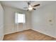 Spacious bedroom with wood-look floors and a window with curtains at 958 Lake Deeson Pt, Lakeland, FL 33805