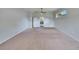 Large bedroom featuring neutral carpet, ceiling fan, and a view out a window at 958 Lake Deeson Pt, Lakeland, FL 33805