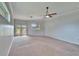 Bright bedroom with neutral carpet, ceiling fan, and access to a patio or backyard area at 958 Lake Deeson Pt, Lakeland, FL 33805