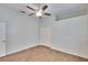 Simple bedroom featuring a ceiling fan, wood floors, and a double-door closet for storage at 958 Lake Deeson Pt, Lakeland, FL 33805