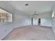 Large bedroom featuring neutral carpet and paint, and a view out a window at 958 Lake Deeson Pt, Lakeland, FL 33805