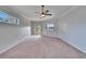 Spacious bedroom with neutral carpet, ceiling fan, and access to a patio or backyard area at 958 Lake Deeson Pt, Lakeland, FL 33805
