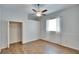 Bedroom featuring wood-look flooring, a ceiling fan, and closet at 958 Lake Deeson Pt, Lakeland, FL 33805