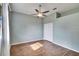 Cozy bedroom featuring a ceiling fan, wood floors, and a double-door closet for ample storage at 958 Lake Deeson Pt, Lakeland, FL 33805