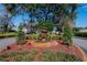 Community entrance with a charming fountain and landscaping at 958 Lake Deeson Pt, Lakeland, FL 33805