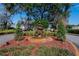Beautifully landscaped community entrance with a tiered fountain and mature trees at 958 Lake Deeson Pt, Lakeland, FL 33805