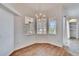 Bright dining area with wood floors, chandelier, and large windows with blinds at 958 Lake Deeson Pt, Lakeland, FL 33805
