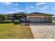 Single-story home with three-car garage and attractive landscaping at 958 Lake Deeson Pt, Lakeland, FL 33805