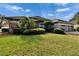 House with a two-car garage and lush green lawn at 958 Lake Deeson Pt, Lakeland, FL 33805