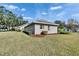 Exterior view showcasing the home's architecture, landscaping, and well-manicured lawn at 958 Lake Deeson Pt, Lakeland, FL 33805