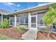 Screened patio with paver walkway and well-manicured landscaping at 958 Lake Deeson Pt, Lakeland, FL 33805