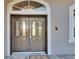 Double front doors with glass inserts add curb appeal at 958 Lake Deeson Pt, Lakeland, FL 33805