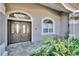 Inviting house entrance featuring double doors and landscaping at 958 Lake Deeson Pt, Lakeland, FL 33805