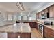 Open kitchen with island, granite counters, wood cabinets and stainless appliances at 958 Lake Deeson Pt, Lakeland, FL 33805