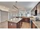 Large kitchen island with granite countertops and dark wood cabinets at 958 Lake Deeson Pt, Lakeland, FL 33805