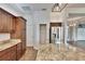Kitchen with stainless refrigerator, granite counters, wood cabinets and center island at 958 Lake Deeson Pt, Lakeland, FL 33805