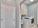 Laundry room with washer, dryer, and upper cabinets at 958 Lake Deeson Pt, Lakeland, FL 33805