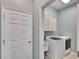Laundry room with washer, dryer, sink and upper cabinets at 958 Lake Deeson Pt, Lakeland, FL 33805