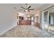 Spacious living room featuring tile floors, ceiling fan, and sliding glass doors to an outdoor patio at 958 Lake Deeson Pt, Lakeland, FL 33805