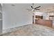 Open living room with tile floors, ceiling fan and eat-in bar to the kitchen area at 958 Lake Deeson Pt, Lakeland, FL 33805