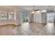 Open concept living room with tile floor, built-in shelves and sliding glass doors at 958 Lake Deeson Pt, Lakeland, FL 33805