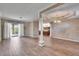Bright living room with wood floors, neutral paint, and access to the kitchen at 958 Lake Deeson Pt, Lakeland, FL 33805