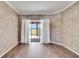 Bright sunroom area with wood floors overlooking the backyard and serene lake view at 958 Lake Deeson Pt, Lakeland, FL 33805