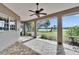 Enjoy scenic views from this screened patio with brick flooring and ceiling fan at 958 Lake Deeson Pt, Lakeland, FL 33805