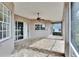 Spacious screened patio with brick flooring, ceiling fan, and multiple access points at 958 Lake Deeson Pt, Lakeland, FL 33805