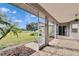 Enjoy outdoor living on this screened patio with brick flooring and lush garden views at 958 Lake Deeson Pt, Lakeland, FL 33805