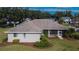A cozy single-story home showcasing a screened-in porch and mature landscaping in the backyard at 958 Lake Deeson Pt, Lakeland, FL 33805