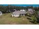 Landscaped backyard featuring a screened-in porch on a charming single-story home at 958 Lake Deeson Pt, Lakeland, FL 33805