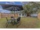 Fenced backyard with patio furniture and large shade tree at 100 Cordova Rd, Auburndale, FL 33823