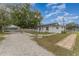 House exterior with gravel driveway and stone walkway at 100 Cordova Rd, Auburndale, FL 33823