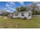 White house with a spacious yard and wooden fence at 100 Cordova Rd, Auburndale, FL 33823