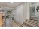 Clean hallway with stairs, closets, and wood-look floors at 100 Cordova Rd, Auburndale, FL 33823