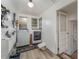 Convenient laundry room with washer, dryer, and built-in storage at 100 Cordova Rd, Auburndale, FL 33823