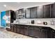 Modern kitchen with dark wood cabinets and granite countertops at 631 Samuel Pl, Davenport, FL 33837