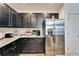 Kitchen with stainless steel refrigerator and dark wood cabinets at 631 Samuel Pl, Davenport, FL 33837