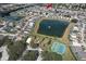 Community aerial view of a neighborhood surrounding a pond and recreational park at 108 Emeraldview Ave, Davenport, FL 33897