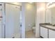 Bathroom featuring a glass door shower and a vanity with a mirror and light fixture at 108 Emeraldview Ave, Davenport, FL 33897