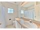 Bathroom features a single vanity, large mirror, toilet and shower/tub combo at 108 Emeraldview Ave, Davenport, FL 33897