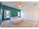 A bedroom featuring two windows and a TV, set against a backdrop of green and white walls at 108 Emeraldview Ave, Davenport, FL 33897