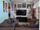 Bright living room with large TV, comfy couches, and wall art at 108 Emeraldview Ave, Davenport, FL 33897