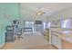 Open concept living room with gaming area, ceiling fan and natural lighting at 108 Emeraldview Ave, Davenport, FL 33897