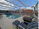 Relaxing screened pool area with patio furniture at 108 Emeraldview Ave, Davenport, FL 33897