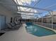 Inviting screened pool with lounge chairs at 108 Emeraldview Ave, Davenport, FL 33897